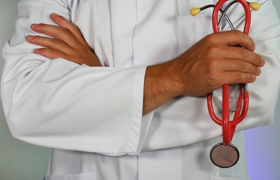 doctor holding a red stethoscope