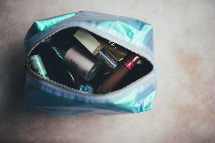 blue open makeup bag with cosmetics inside