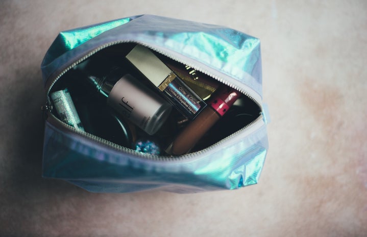 blue open makeup bag with cosmetics inside