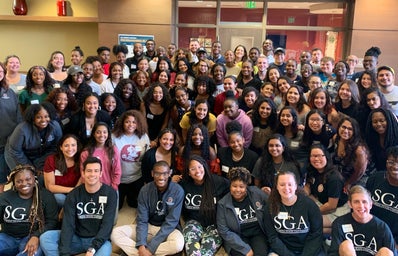 There are people wearing SGA shirts in the front. This picture was taken at SGA All-Agency Meeting