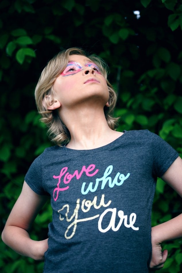 young girl with shirt that says love who you are