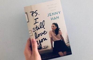 Someone holding a copy of the book \"P.S. I Still Love You\"