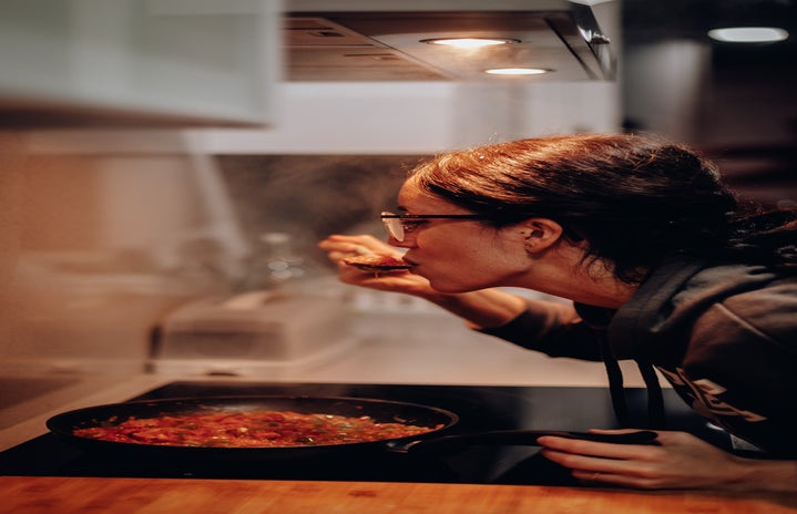 woman eating on cooking pan 1587830?width=719&height=464&fit=crop&auto=webp