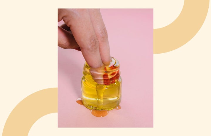 fingers in jar of oil