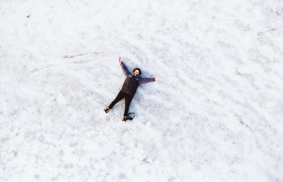 person laying in the snow