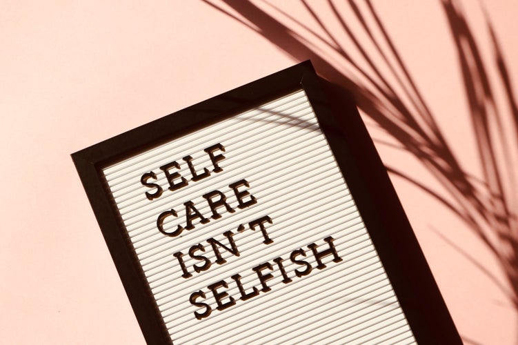 Board that says “Self Care isn’t Selfish”