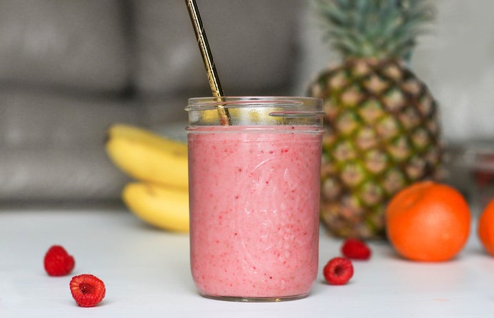 fruit smoothie in glass with metal straw
