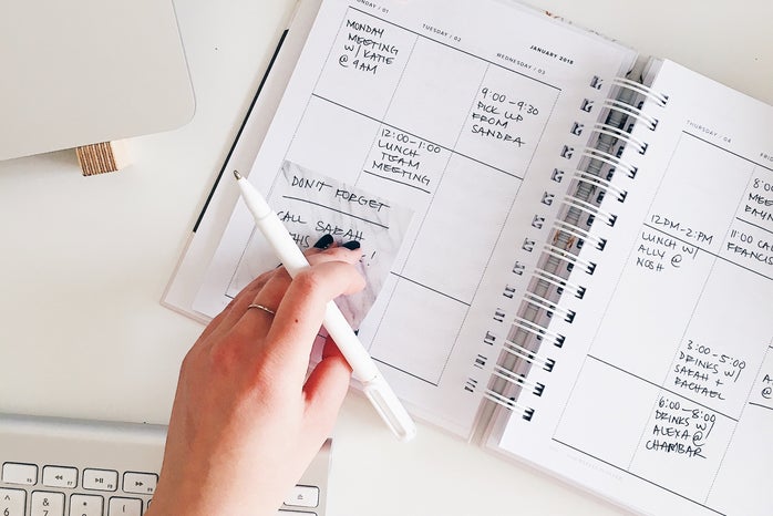 girl using planner to check off events