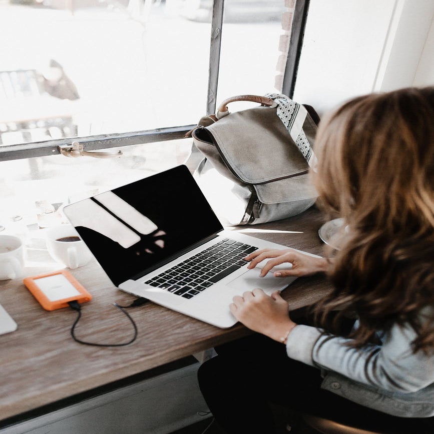 woman at desk working on laptop