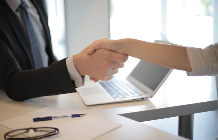 two people shaking hands business