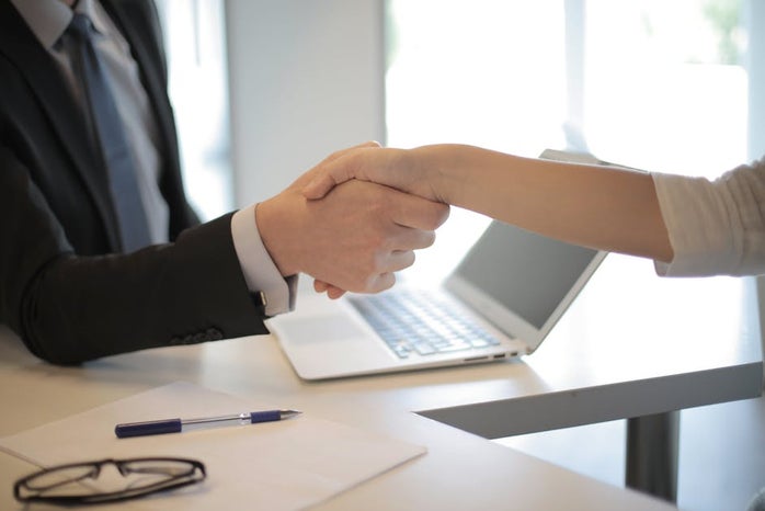 two people shaking hands business