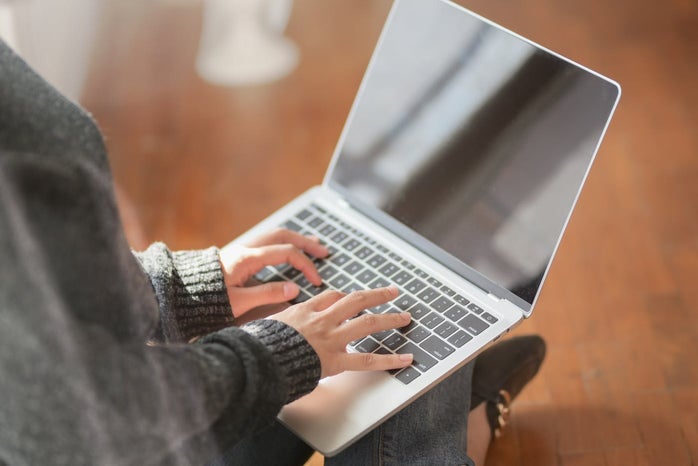 woman typing on a laptop