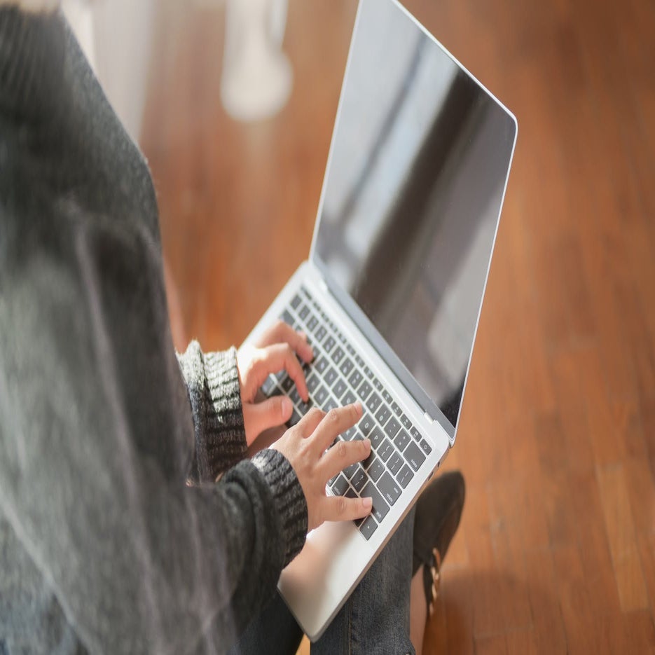 woman typing on a laptop