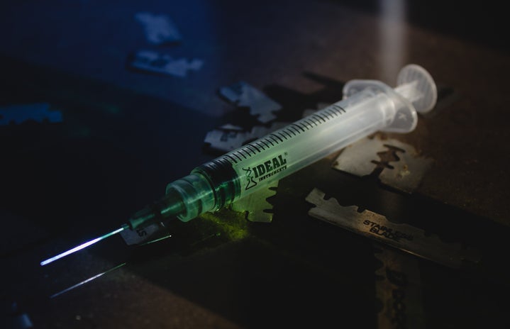 Syringe with green liquid