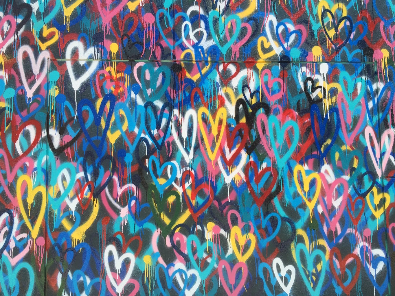 Colorful spray paint hearts wall