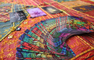 tarot cards spread out over a colorful tablecloth
