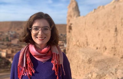 Woman in pink scarf in a desert