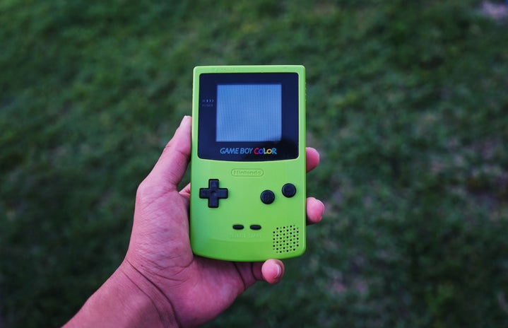 Person holds green Gameboy Color