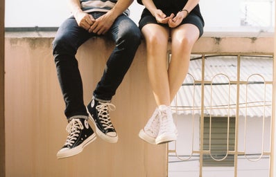 couple sitting on wall