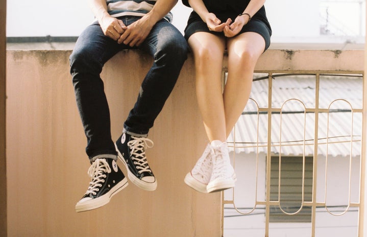 couple sitting on wall