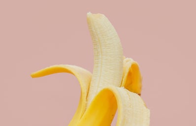 banana fruit peeled on pink background?width=398&height=256&fit=crop&auto=webp