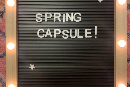 spring capsule sign on a rug