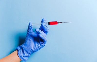 Person holding syringe