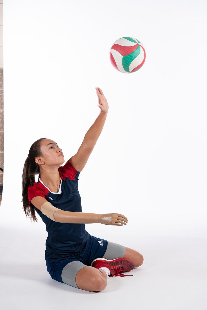 Volleyball Player sitting and hitting ball with one arm