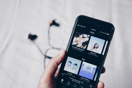 Phone and headphones with Spotify open