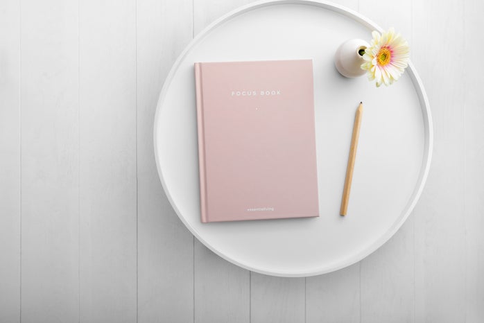pink notebook on white dish