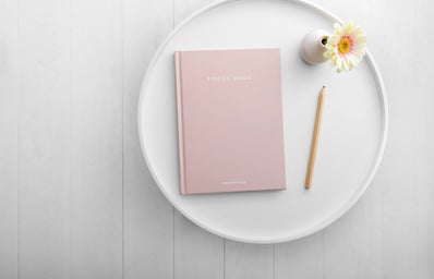 pink notebook on white dish