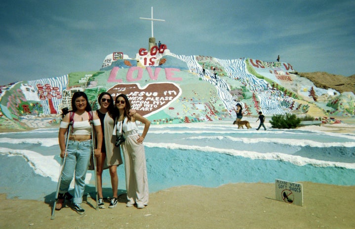 3 girls in front of salvation mountain
