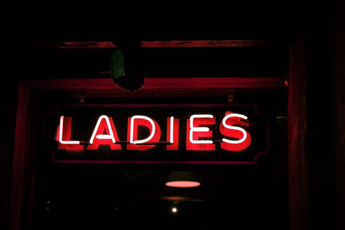 Red neon light singnage that says 'ladies'