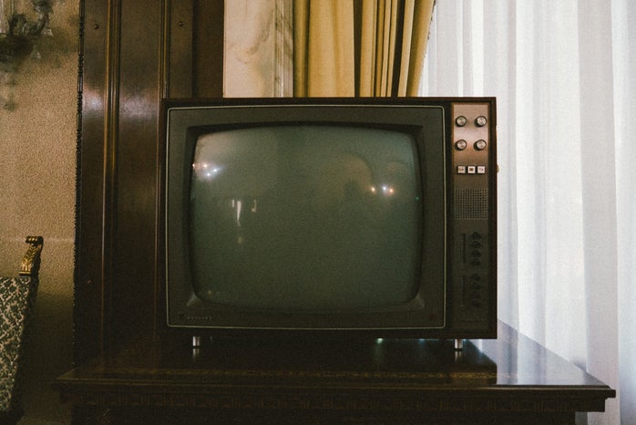 turned off gray CRT TV on table