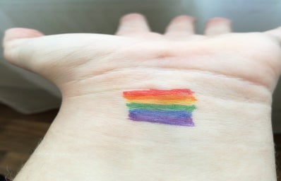 hand with lgbt pride flag