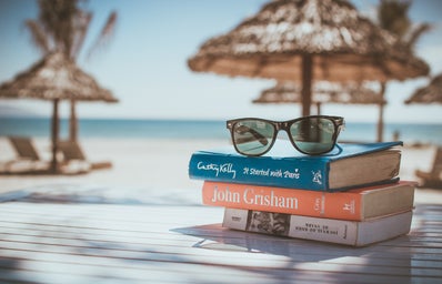 Books stacked in front of a beach