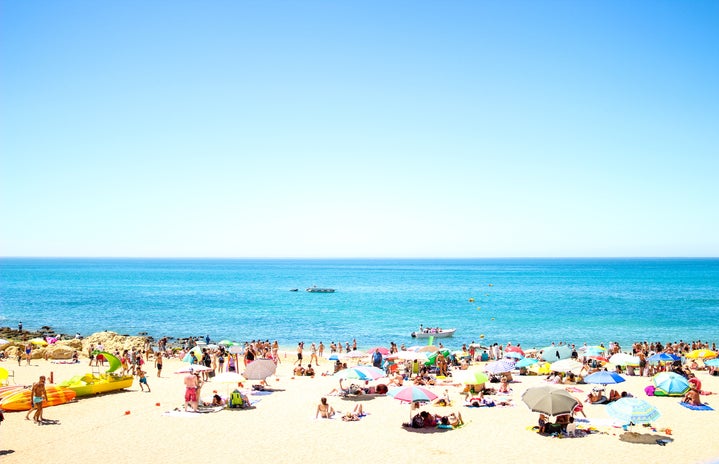 crowd on beach under blue sky oliveirajpg by Denis Oliveira?width=719&height=464&fit=crop&auto=webp