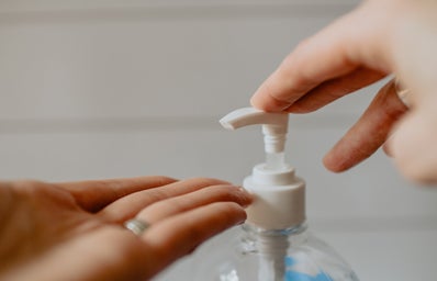 person using hand sanitizer pump
