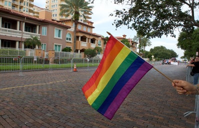 hand holding pride flag at pride parade