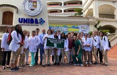 study abroad group with MSU flag at UNIBE