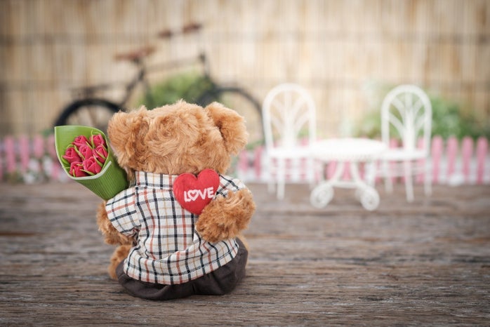 brown bear plush toy holding red rose flower 1028729jpg?width=698&height=466&fit=crop&auto=webp