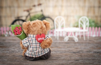 brown bear plush toy holding red rose flower 1028729jpg?width=398&height=256&fit=crop&auto=webp