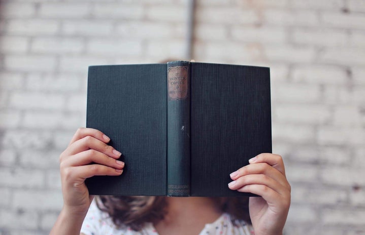 Selective Focus Photography of Woman Holding Book