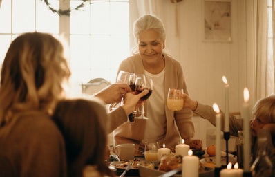woman on gray cardigan standing near table doing cheers 3171199jpg?width=398&height=256&fit=crop&auto=webp