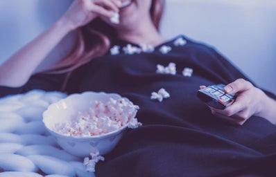 Woman Wearing Black Dress Shirt Eating Popcorn