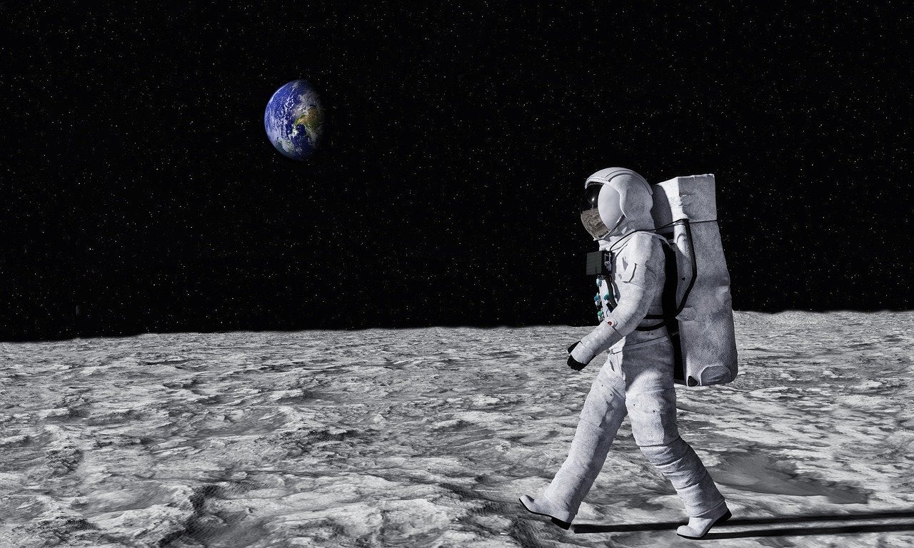 Astronaut walking across moon