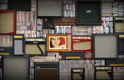 Various speakers and musical records. Image of Elvis Presley centered.