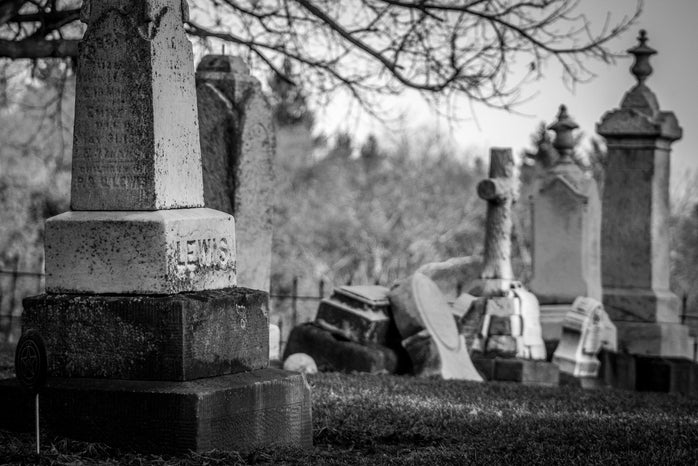 grayscale photo of tombstones in a graveyard