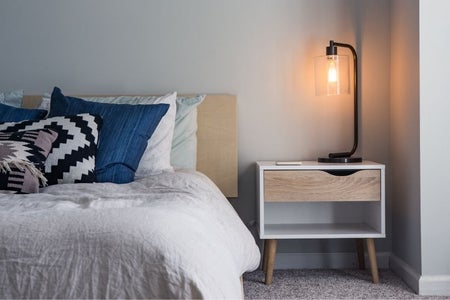 navy and white themed bed with side table