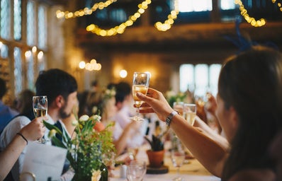 People raising champagne glasses at a wedding party